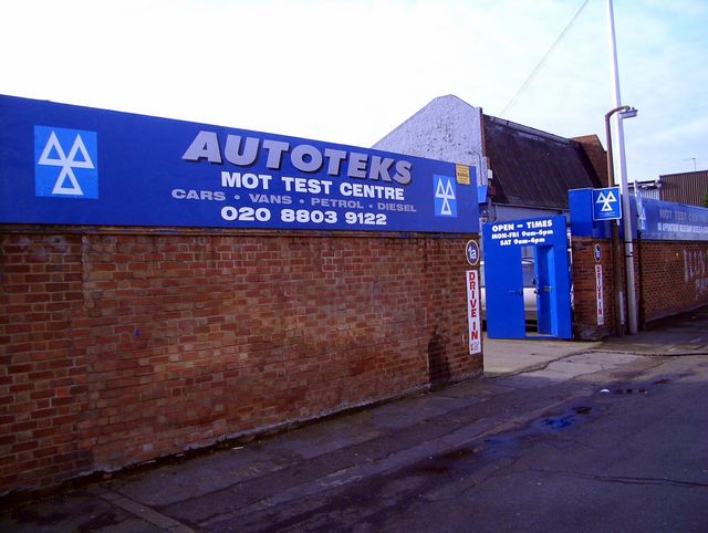 The Autoteks MOT Test Centre sign and blue gates on Shaftesbury Road